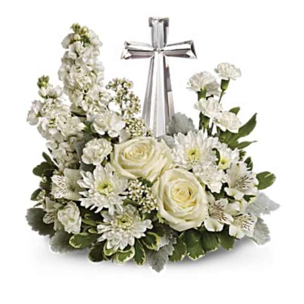 White floral arrangement with a silver cross centerpiece
