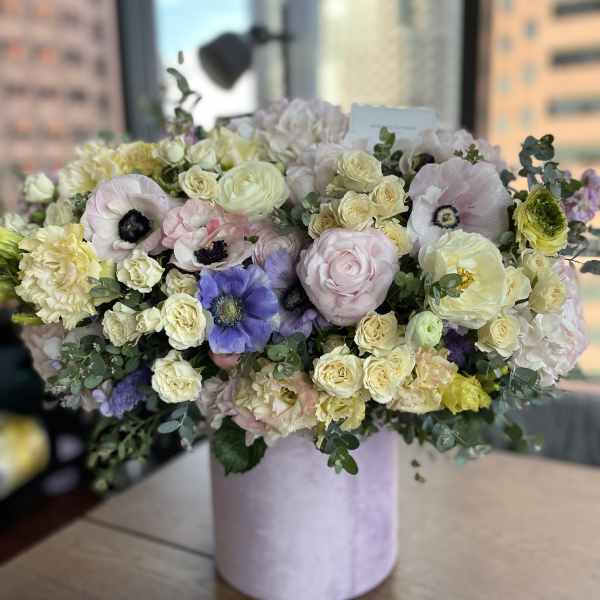 Large pastel bouquet in a pink cylindrical box