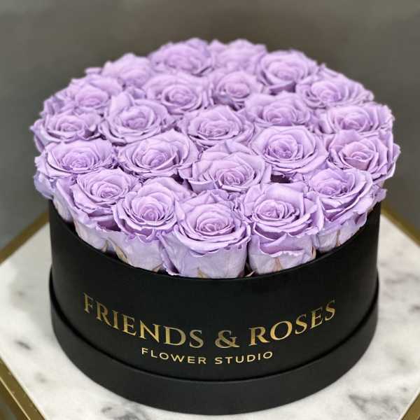 Lavender roses arranged in a round black box