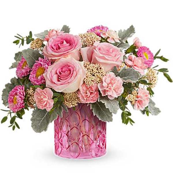 Pink roses and carnations in a pink glass vase