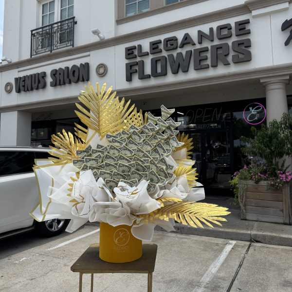 Money bouquet with gold and white decorative paper in a yellow container