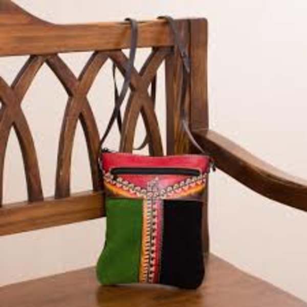 Colorful patterned handbag on a wooden chair