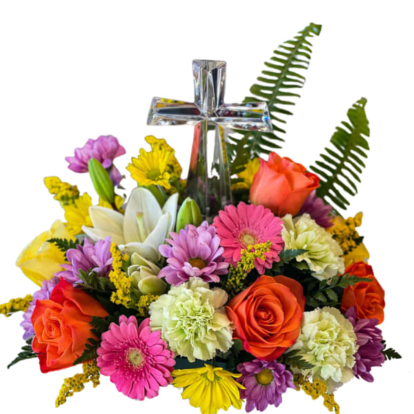 Colorful flower arrangement with a silver cross centerpiece