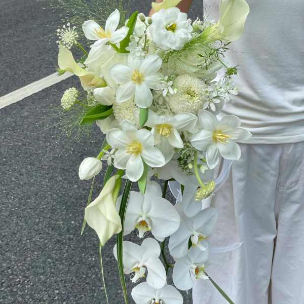 White bridal bouquet with orchids, calla lilies, and tulips