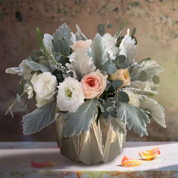 Blush and white bouquet in a faceted ceramic vase