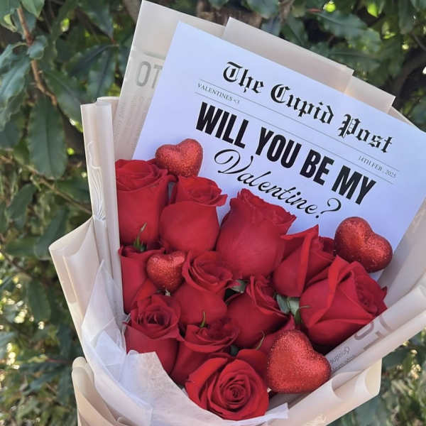 Red rose bouquet with glittery heart decorations and a Valentine card