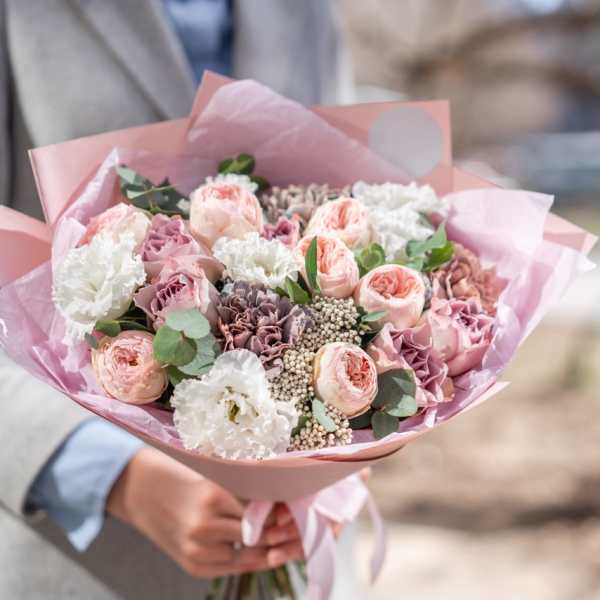 Pink and white bouquet of mixed flowers wrapped in pink paper