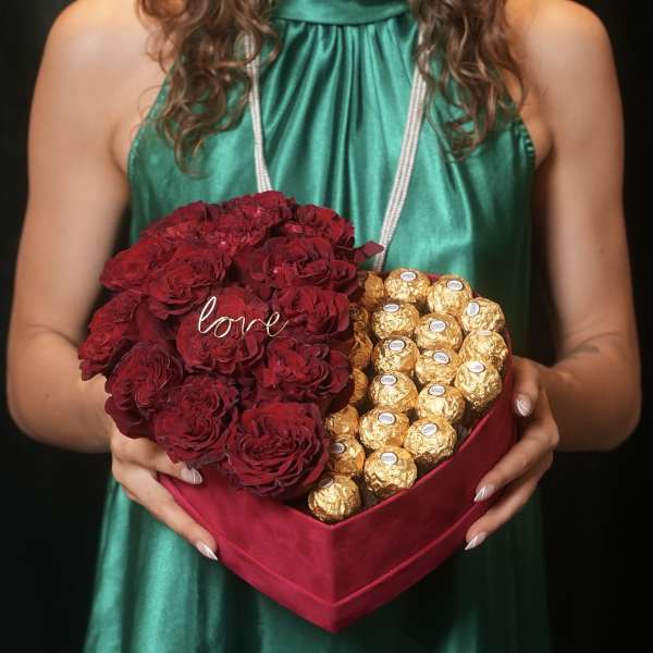 Heart-shaped box with red roses and gold-wrapped chocolates