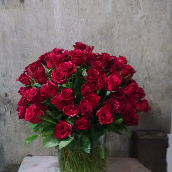 Large bouquet of red roses in a clear glass vase