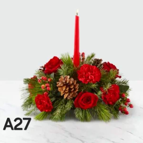 Red floral centerpiece with a tall red candle and pinecones