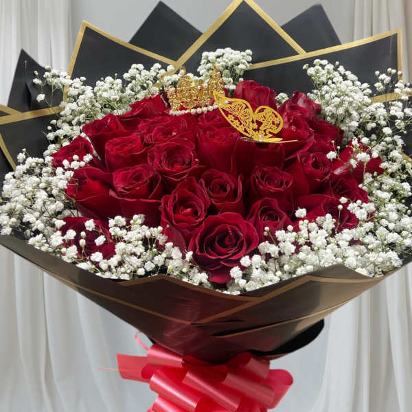 Bouquet of red roses with white baby's breath and a red ribbon wrap