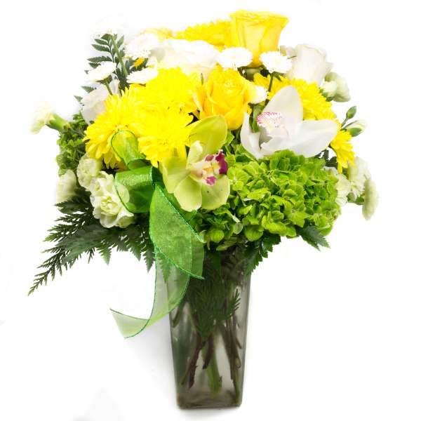 Yellow and white floral arrangement in a glass vase with a green ribbon