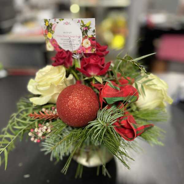 Red and white roses with a glittery red ornament and ribbon