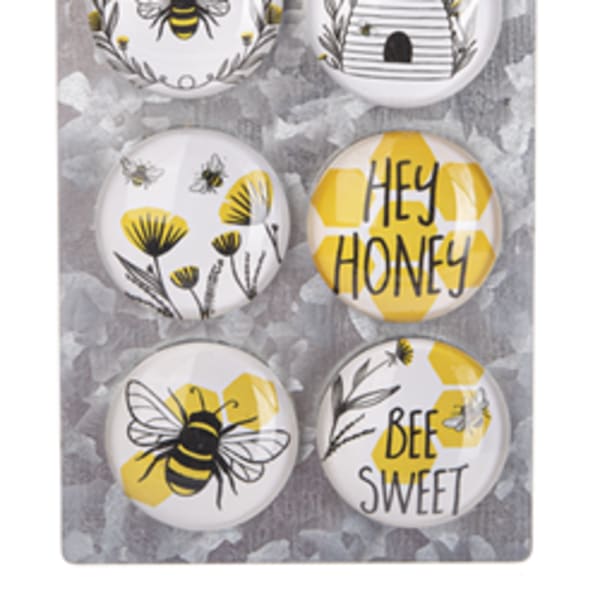 Set of six bee-themed decorative magnets on a hanging board