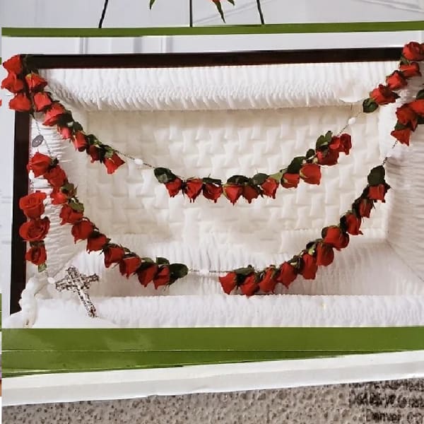 Red rose garlands arranged in a white presentation box