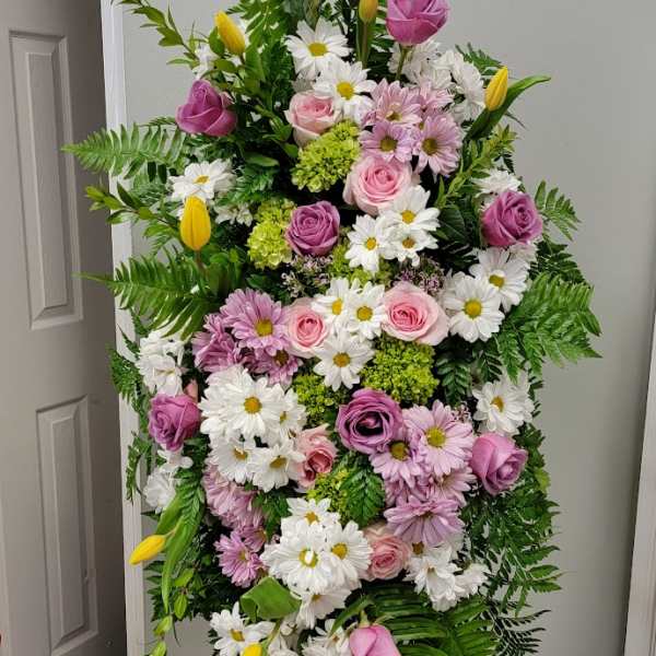 Tall standing floral spray with pink roses, white daisies, and yellow tulips