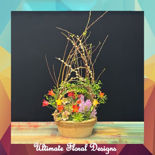 Tall floral arrangement in a woven basket with colorful blooms and branches