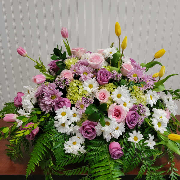 Large mixed bouquet of pink and purple roses with white daisies and yellow tulips