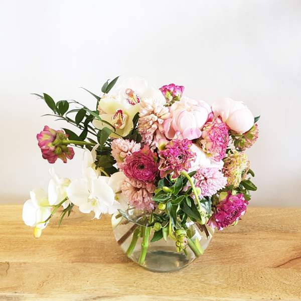 Pink and white floral arrangement in a clear glass vase
