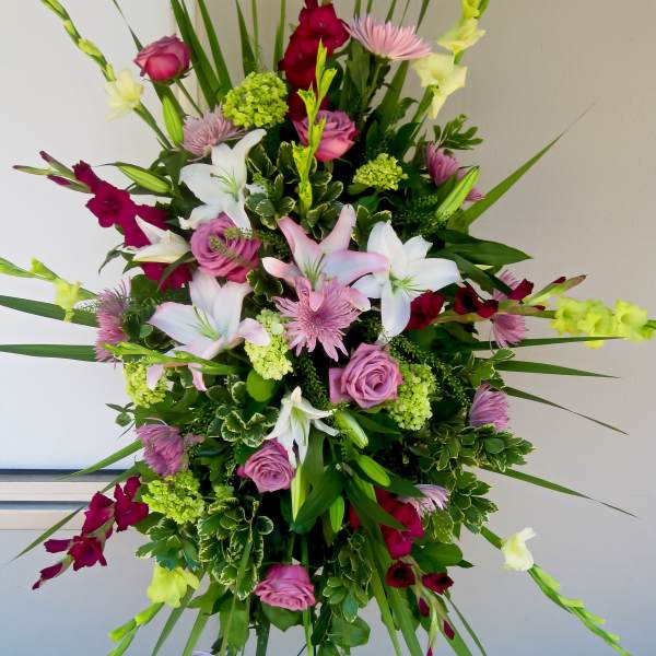 Tall floral spray with pink, white, and burgundy blooms