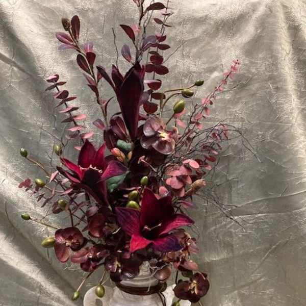 Deep burgundy floral arrangement in a white vase