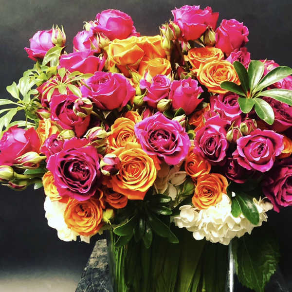 Bouquet of pink and orange roses in a glass vase