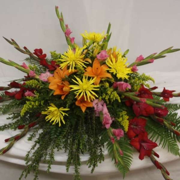 Colorful floral centerpiece with red, orange, and yellow blooms