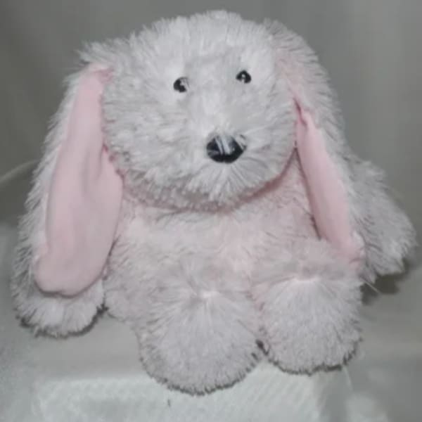 White plush bunny with pink ears and black eyes