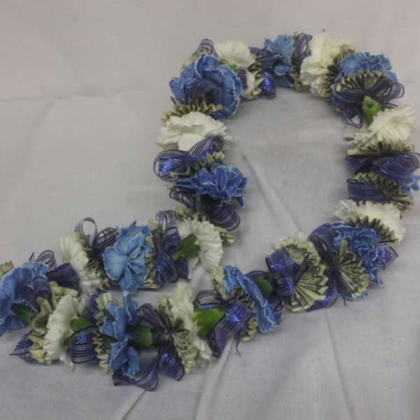 Blue and white flower lei on a light fabric background