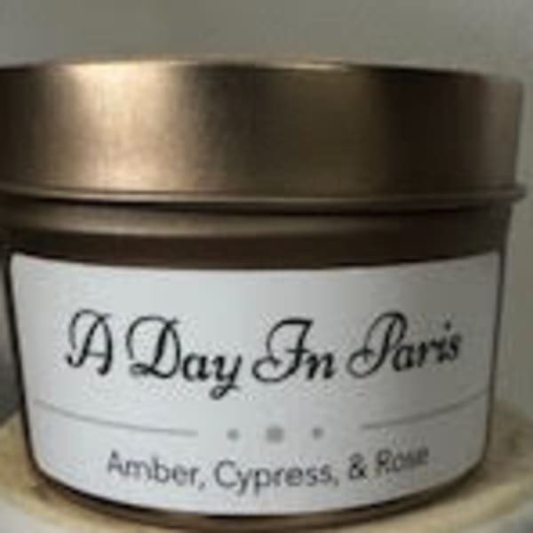 Scented candle in a metal tin with a white label