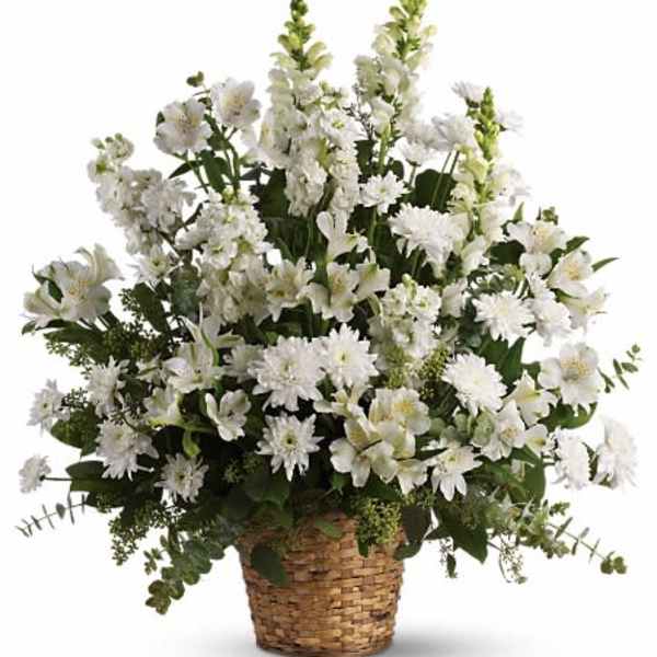 White floral arrangement in a woven basket