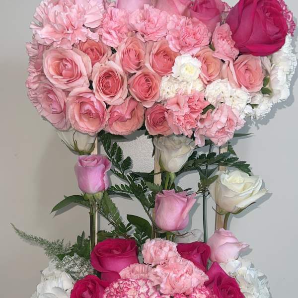 Pink and white rose arrangement in a glittery rectangular container