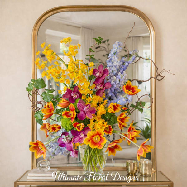 Colorful mixed flower arrangement in a clear glass vase