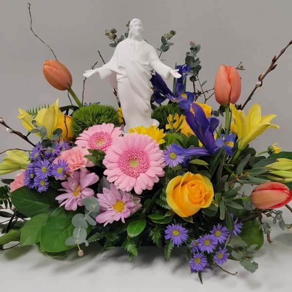 Colorful floral arrangement with a white statue centerpiece