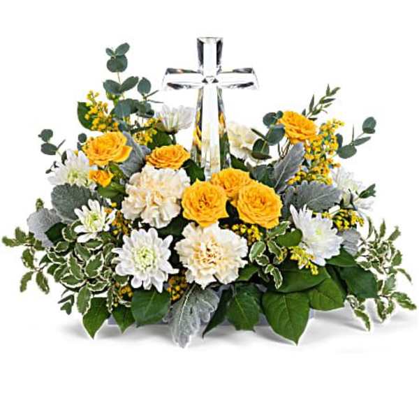Yellow and white flower arrangement with a clear cross centerpiece