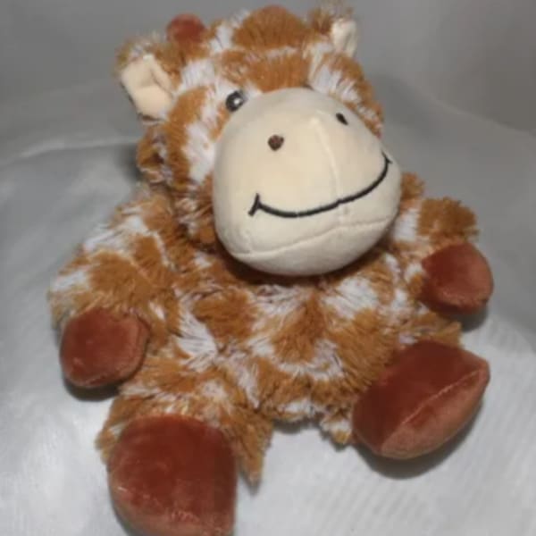 Plush giraffe toy with a smiling face and brown-and-white fur