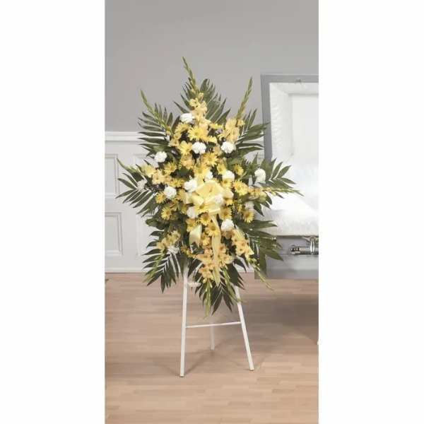 Standing floral spray with yellow and white flowers on an easel