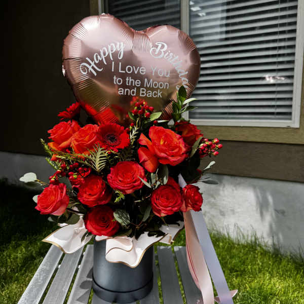 Red rose bouquet with a heart-shaped birthday balloon in a black box