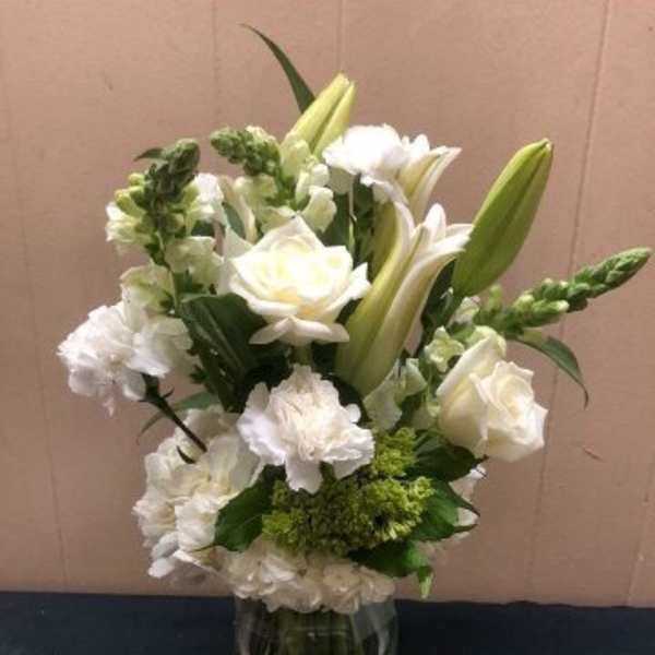 White floral arrangement in a clear glass vase