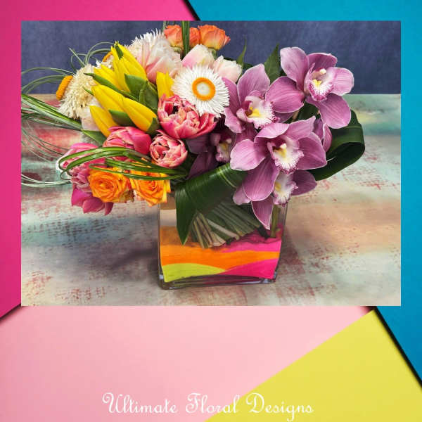 Mixed bouquet with purple orchids in a square glass vase