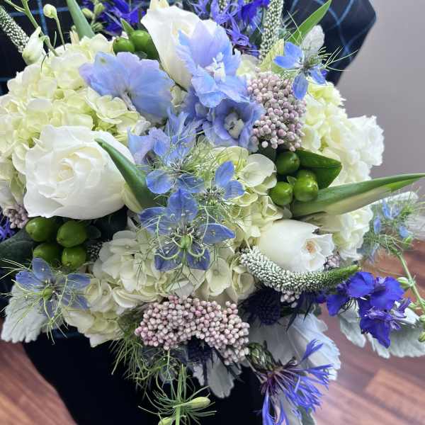 Bouquet of white and blue flowers with green accents