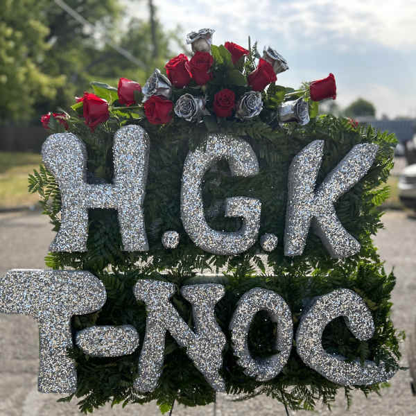 Glittery H.G.K. T.NOC sign with red roses and a red ribbon
