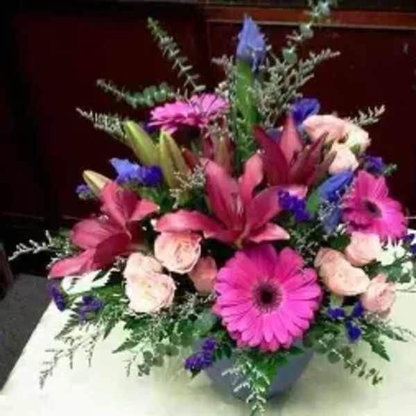 Pink and purple mixed flower arrangement in a vase