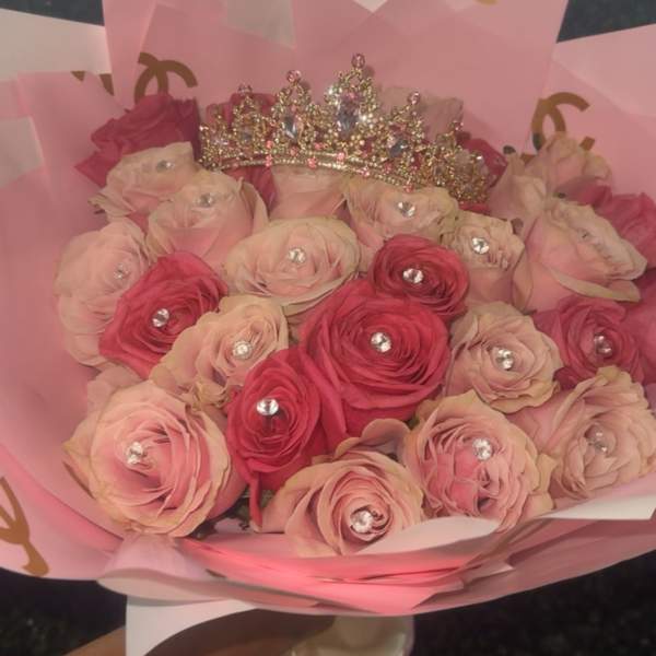 Pink and blush rose bouquet with a jeweled crown topper