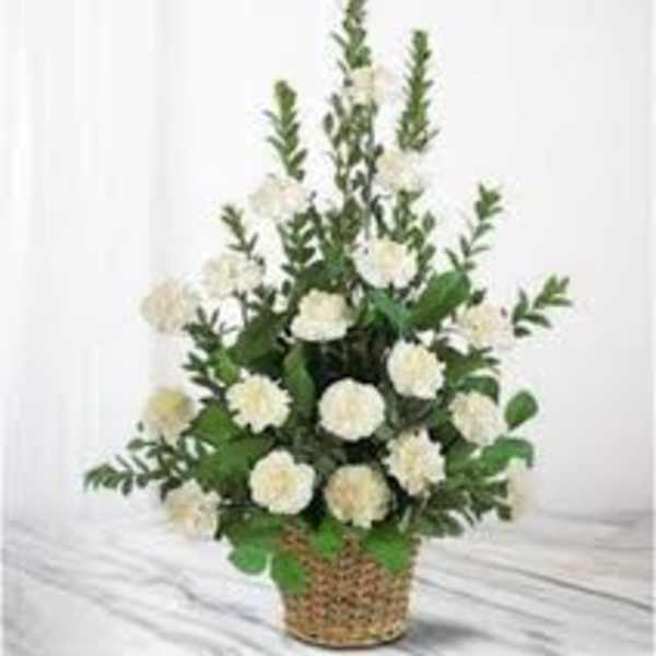 White carnation arrangement in a woven basket
