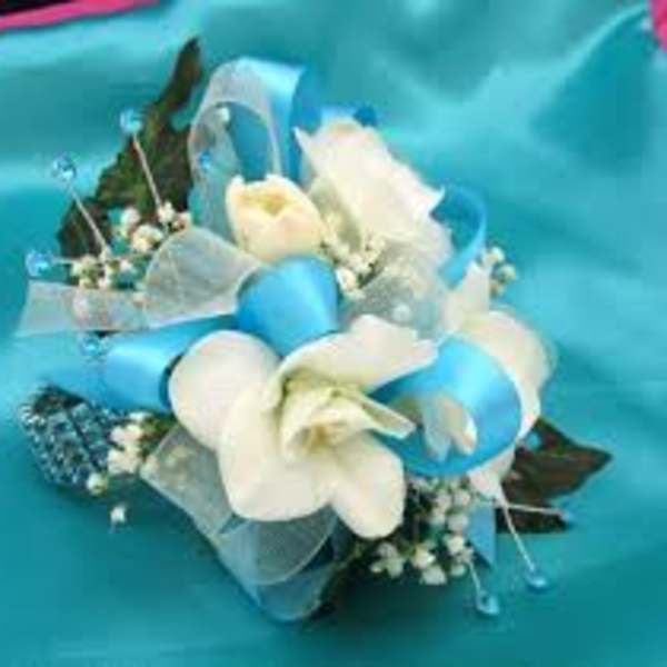 White flowers with blue ribbon and translucent wrap on a turquoise background