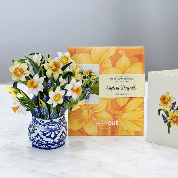 Pop-up bouquet of yellow and white daffodils in a blue patterned pot with a card