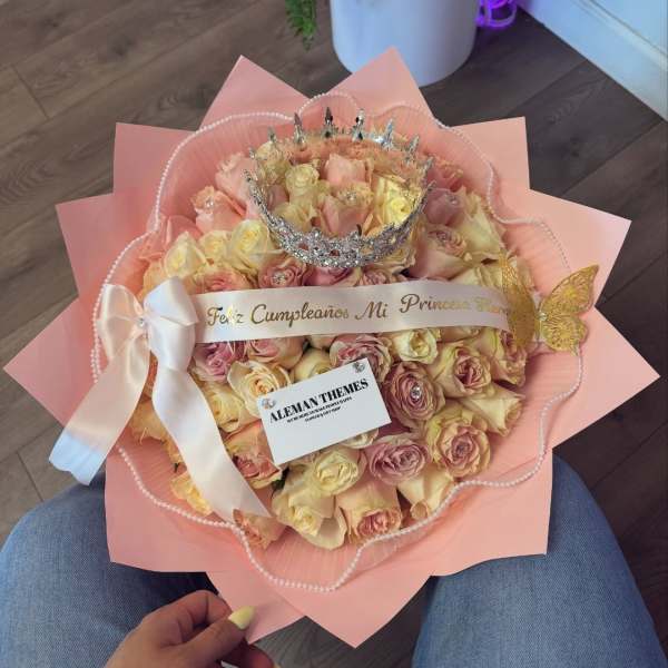 Bouquet of pale pink and cream roses with a silver crown and ribbon