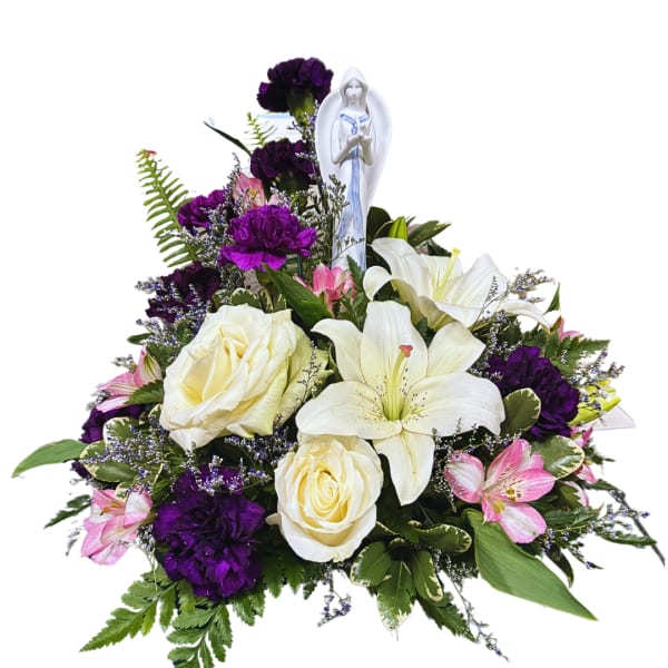 White roses and lilies with purple carnations and a small angel figurine