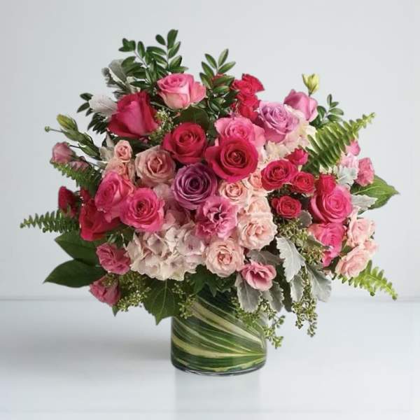 Pink and red rose bouquet in a glass vase